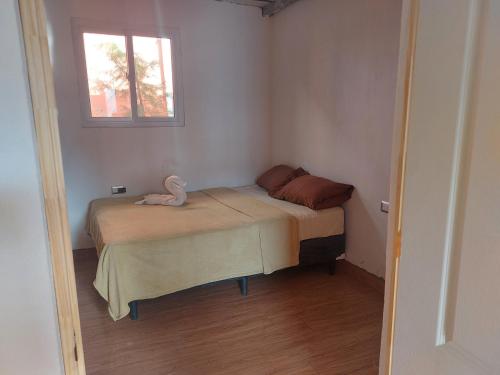 a small bedroom with a bed and a window at Casa non in Guatemala