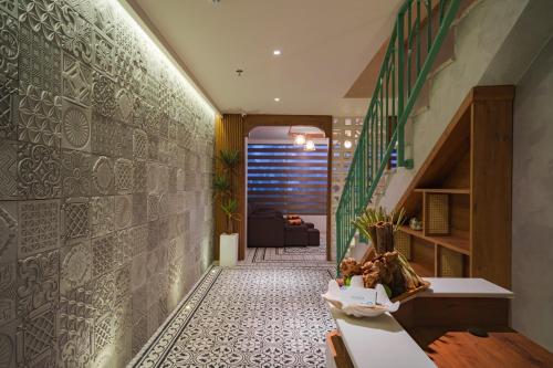 a hallway with a stone wall and a staircase at Seaesta Nha Trang Hotel in Nha Trang