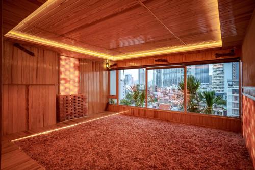 a room with a large window with a view of a city at Seaesta Nha Trang Hotel in Nha Trang