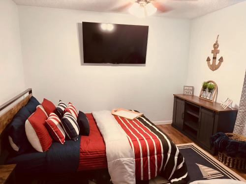a bedroom with a bed and a television on the wall at Jet Skis, Lake View, Sleeps 8, HotTub, Firepit, Pet Friendly! in Canyon Lake