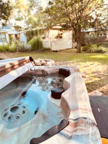 a pool of water in a backyard with a table at Jet Skis, Lake View, Sleeps 8, HotTub, Firepit, Pet Friendly! in Canyon Lake