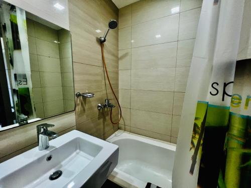 a bathroom with a sink and a shower and a tub at 1br Apartments Mactan New Town free Pool free Beach near Airport Ocean view in Punta Engaño