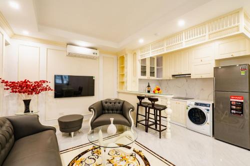 a kitchen and living room with a couch and a table at Wild Lotus Hotel Apartment 2 in Hanoi