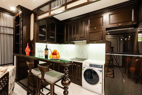 a kitchen with a washer and dryer in it at Wild Lotus Hotel Apartment 2 in Hanoi