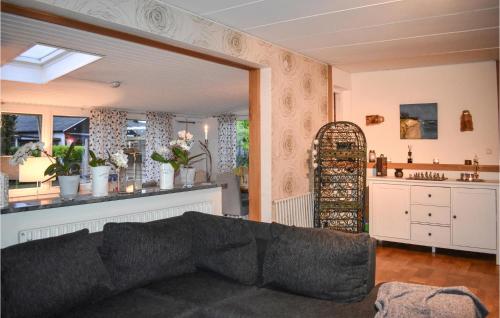 a living room with a couch and a mirror at 4 Bedroom Pet Friendly Home In Simrishamn in Simrishamn