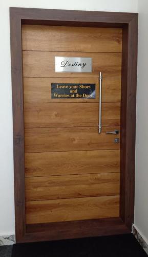 a wooden door with a sign on it at Reunion Ocean Manor - Beach House in Udupi