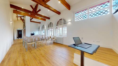 a room with a table with a laptop on it at DOMAINE DE LA TISNERE in Gelos