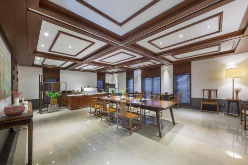 a large dining room with a coffered ceiling at Floral Hotel ·Hefu Hotel (Hangzhou West Lake) in Hangzhou