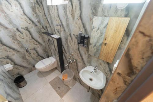 a bathroom with a sink and a toilet at Air Avenue Hotel - Airport in Devanahalli-Bangalore