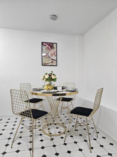 a dining room with a table and chairs at Boutique Hotel Honey in Kutaisi