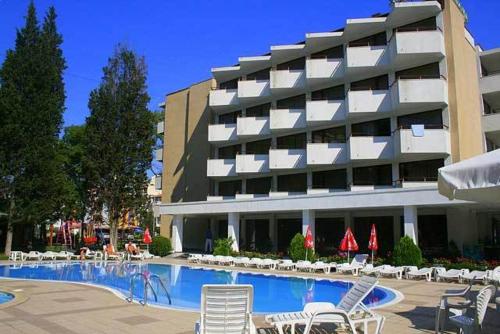 a hotel with a swimming pool with chairs and a building at Hotel Klisura in Sunny Beach