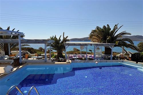 a large swimming pool with a view of the ocean at Hotel Dolphin St Giorgio in Agios Georgios
