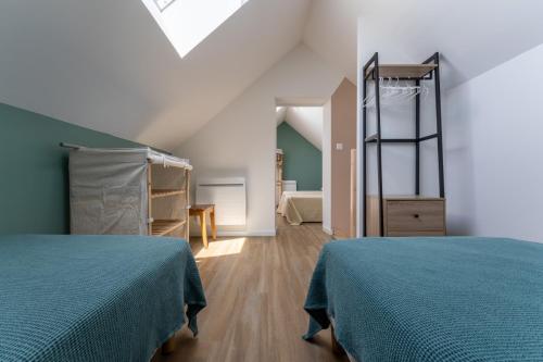 a bedroom with two beds and a ladder at Gite Cascades du Hérisson 3 chambres piscine in La Châtelaine