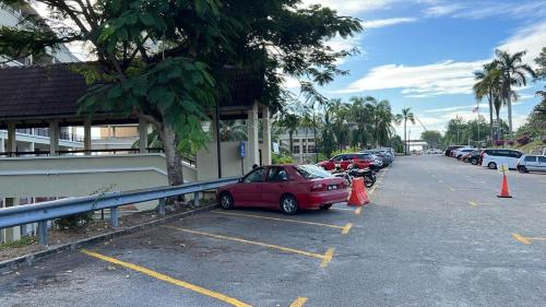 a red car parked in a parking lot at Port Dickson Seaview Homestay in Port Dickson