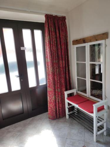 a room with a door and a red curtain at Casa di Volce - 1801 Stone House in Tolmin
