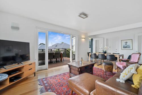 a living room with a couch and a flat screen tv at Stunning newly renovated home in perfect location in Hobart