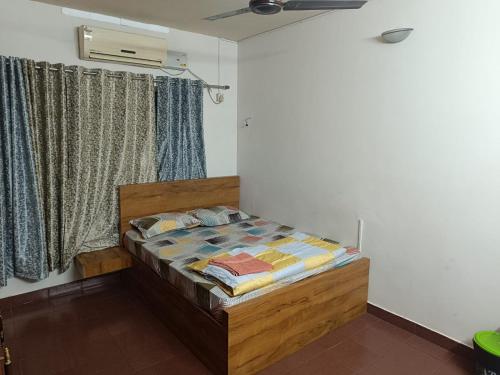 a bedroom with a bed in a room with a window at Ritu Homestay (The Second Wind) in Trivandrum