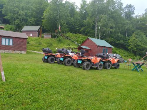 a row of four atvs parked in a yard at Kolibe Ćorić in Mojkovac