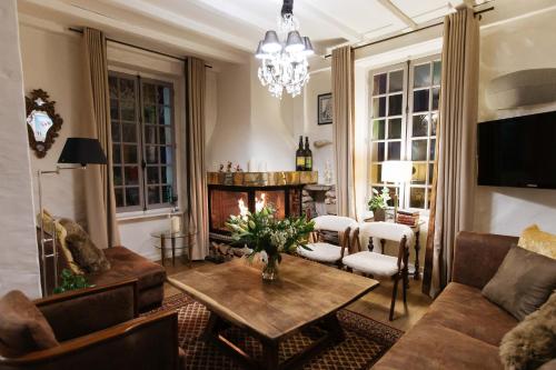 a living room with a table and a fireplace at Coeur des Neiges in Saint-Gervais-les-Bains