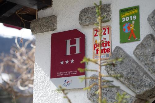 a sign on the side of a building with signs on it at Coeur des Neiges in Saint-Gervais-les-Bains
