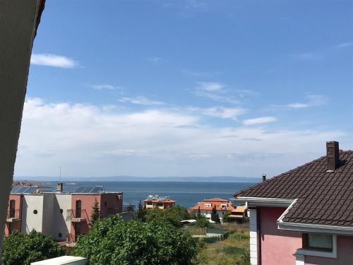 a view of the ocean from the roofs of houses at Апартхотел Созополски перли in Sozopol