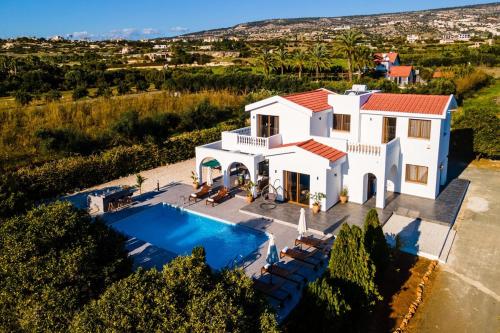 an aerial view of a house with a swimming pool at Cocoon Luxury Villa In Coral Bay-3 Min To Beach in Peyia