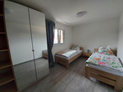 a room with two beds and a glass partition at Penzion - VILA VERI 1 in Ostrava