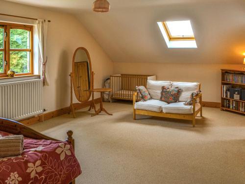 a living room with a chair and a mirror at Argentum House in Boulmer