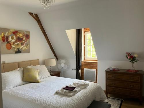 a bedroom with a bed with a dresser and a window at La Tuilerie Grange (Adults only gite) with two en-suite double bedrooms in Le Bugue
