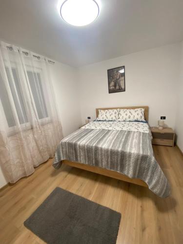 a bedroom with a bed and a large window at Roberto in Fažana