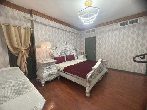 a bedroom with a white bed and a lamp and a table at Private Hall Room Bed Room and Washroom Room In Shared Apartment Flat 302-1 in Abu Dhabi