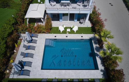 an overhead view of a swimming pool in front of a house at Villa Karolina Luxury Pool Villa Desenzano del Garda in Desenzano del Garda