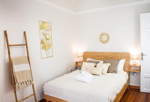 a bedroom with a bed with white sheets at Acropolis Rooftop Monastiraki Centrral Gem in Athens