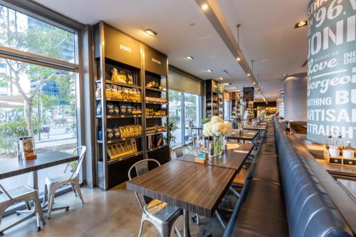 a restaurant with tables and chairs and a bar at Super 2 Bedroom Sea Front (City View) in Abu Dhabi