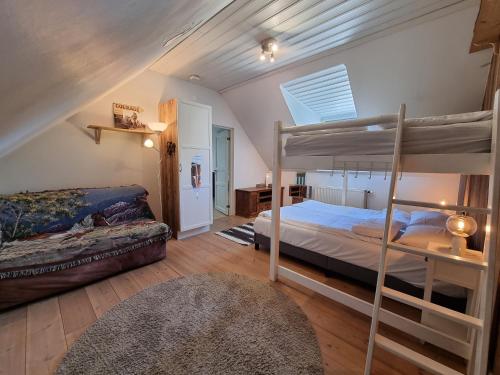 ein Schlafzimmer mit einem Etagenbett und einem Sofa in der Unterkunft EddyLou Ranch in Slöinge
