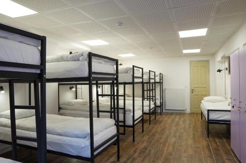 a row of bunk beds in a room at Hotel and Hostel Ticiani 15 in Kutaisi