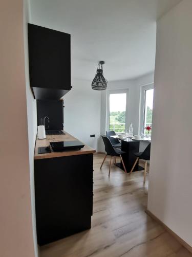 a kitchen and dining room with a dining table at Apartma KORPEC in Ivanjkovci