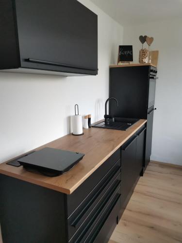 a kitchen with a stove and a counter top at Apartma KORPEC in Ivanjkovci