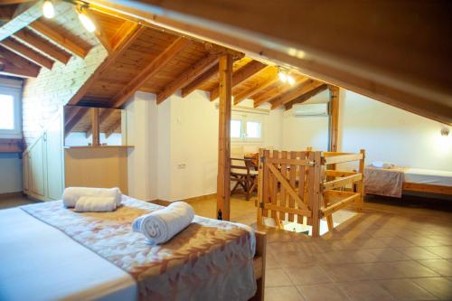 a bedroom with a bed and a dining room at Alexandros Hotel Apartments in Vourvourou