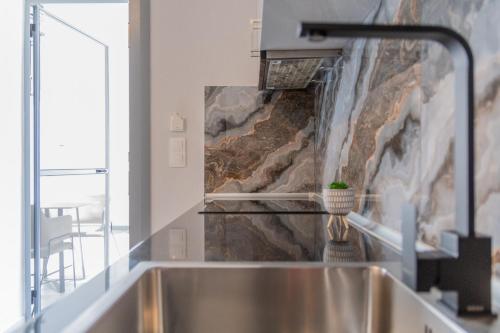 a kitchen with a sink and a waterfall at Pantzos House in Paradisos