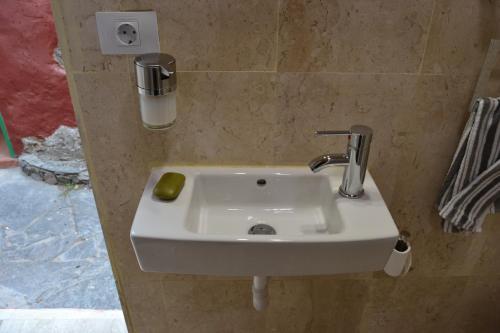 a sink in a bathroom with a lime on it at Casa Cueva El Pedregal Tejeda in Tejeda