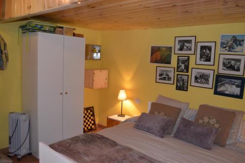 a bedroom with a bed and pictures on the wall at Casa Cueva El Pedregal Tejeda in Tejeda