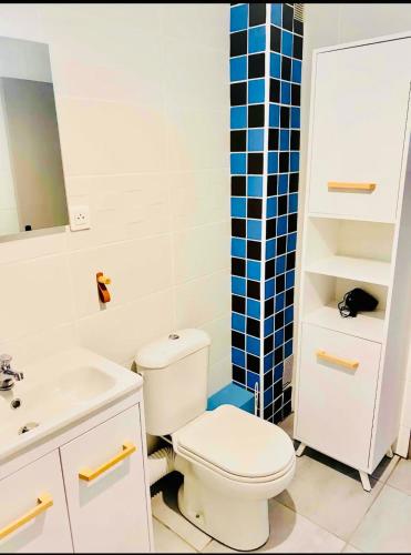 a bathroom with a white toilet and a sink at Face a la mer Fleury in Fleury