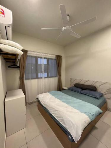 a bedroom with a bed and a ceiling fan at Modern Design with Smart TV in Kuala Lumpur