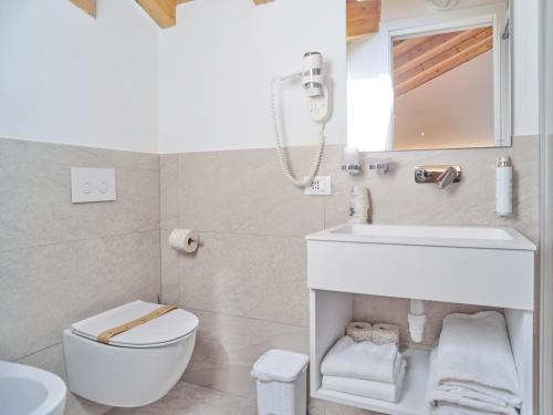 a bathroom with a white sink and a toilet at Hotel Medusa in Finale Ligure