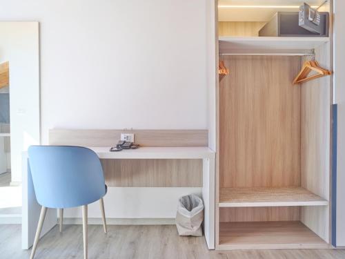 a room with a desk and a blue chair at Hotel Medusa in Finale Ligure