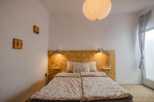 a bedroom with a bed with a brick wall at Little Bispo Apartments in Vila do Bispo