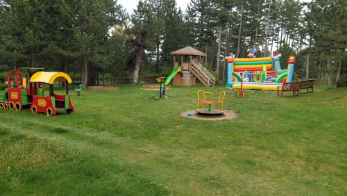 a park with a playground with a train and slides at Сладко студио в Пирин с голф и СПА комплекс in Razlog