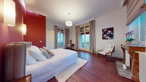 a bedroom with a white bed and a fireplace at DOMAINE DE LA TISNERE in Gelos