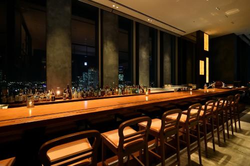 a long bar in a restaurant with a view of the city at Nagoya Prince Hotel Sky Tower in Nagoya